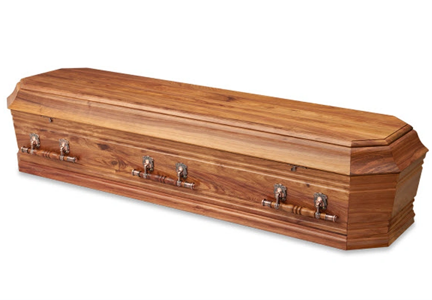 Closed wooden coffin with decorative metal handles on a white background.